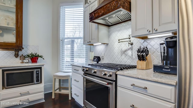 4742 Southern Pkwy, Louisville, KY 40214 - kitchen with premium range hood, white cabinets, stainless steel appliances, and glass insert cabinets