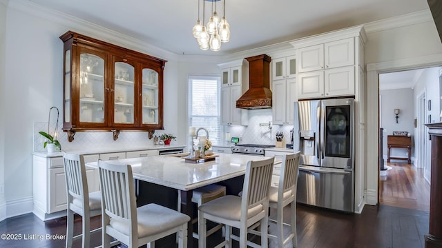4742 Southern Pkwy, Louisville, KY 40214 - kitchen with custom range hood, ornamental molding, dark wood finished floors, a kitchen island with sink, and appliances with stainless steel finishes
