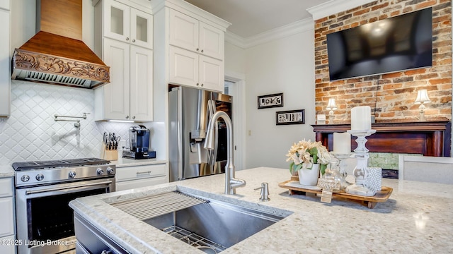 4742 Southern Pkwy, Louisville, KY 40214 - kitchen featuring crown molding, premium range hood, decorative backsplash, light stone counters, and appliances with stainless steel finishes
