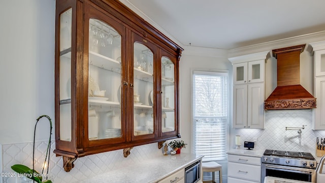 4742 Southern Pkwy, Louisville, KY 40214 - kitchen with glass insert cabinets, premium range hood, white cabinets, and stainless steel appliances