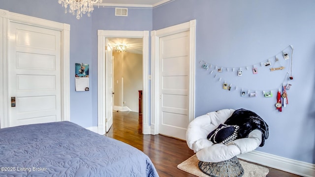 4742 Southern Pkwy, Louisville, KY 40214 - bedroom featuring baseboards, visible vents, a notable chandelier, and wood finished floors