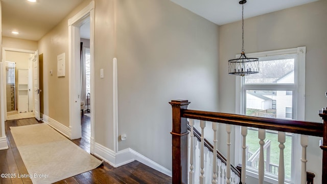4742 Southern Pkwy, Louisville, KY 40214 - corridor featuring dark wood finished floors, baseboards, an upstairs landing, and a chandelier