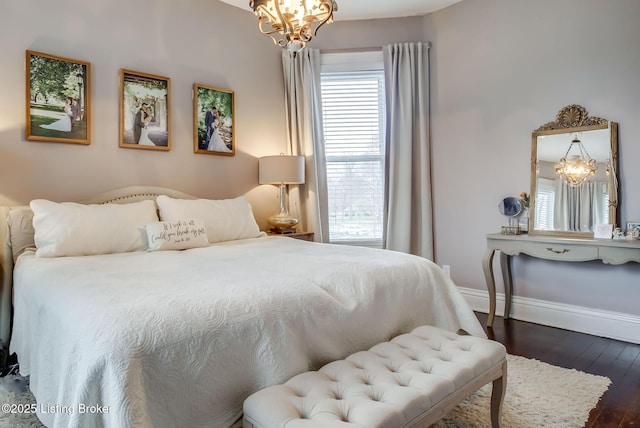 4742 Southern Pkwy, Louisville, KY 40214 - bedroom featuring dark wood-type flooring, baseboards, and an inviting chandelier