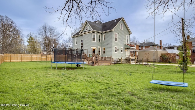 4742 Southern Pkwy, Louisville, KY 40214 - back of property with a lawn, fence, a trampoline, and a wooden deck
