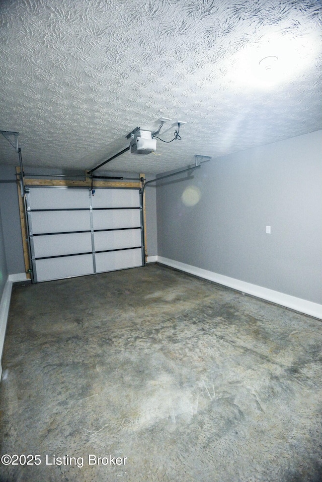 garage with a garage door opener and baseboards