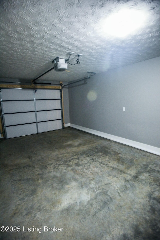 garage with baseboards and a garage door opener