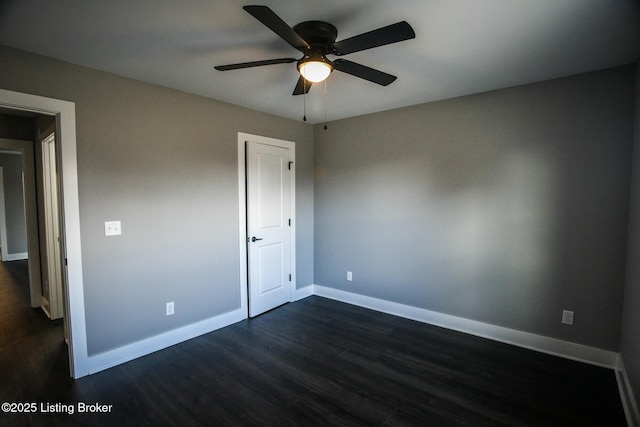 unfurnished bedroom featuring a ceiling fan, dark wood-type flooring, and baseboards