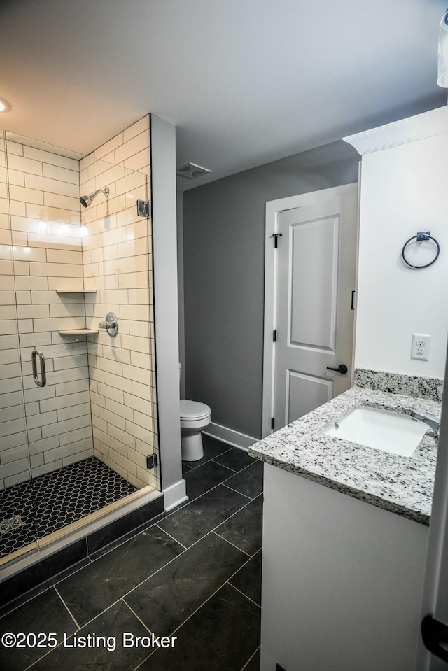 full bathroom with vanity, baseboards, visible vents, a stall shower, and toilet