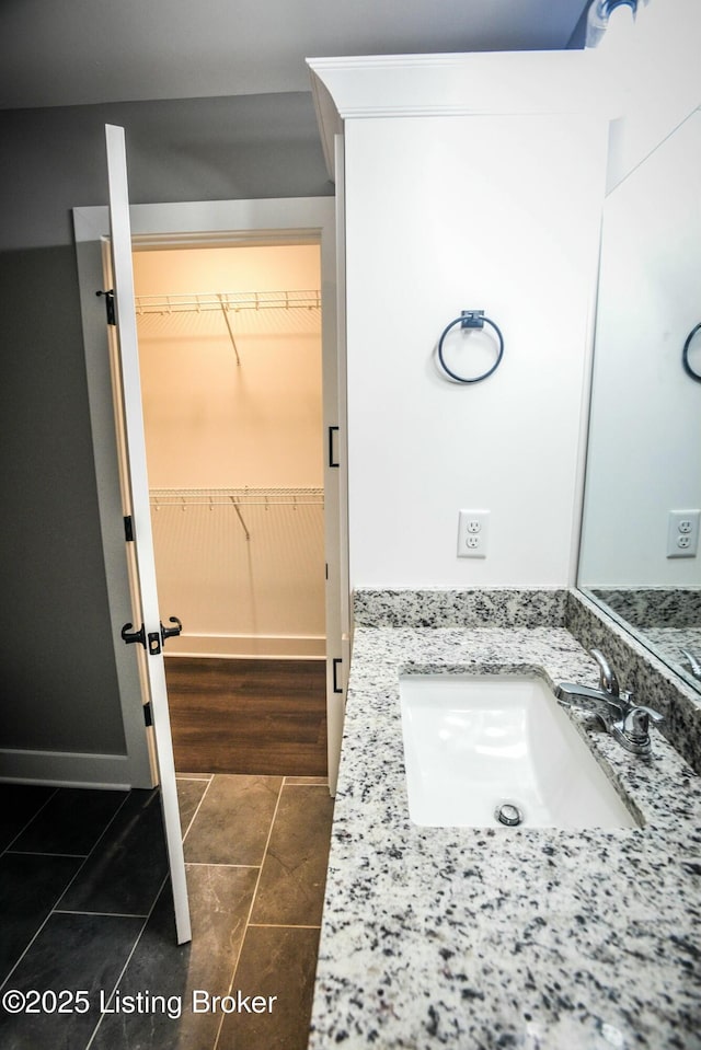 bathroom featuring vanity and a spacious closet