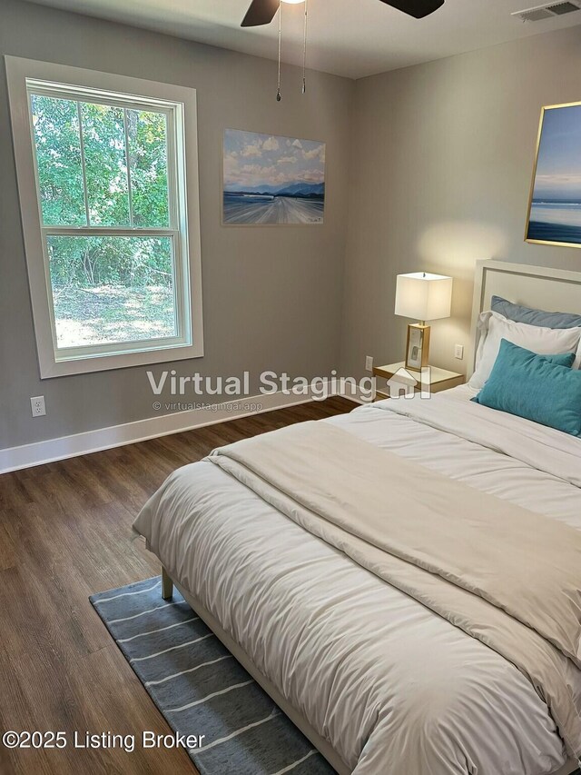 bedroom featuring visible vents, baseboards, and wood finished floors