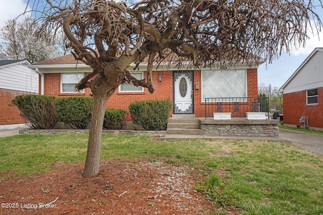 3217 Wellingmoor Ave, Louisville, KY 40218 - view of front facade with brick siding and a front yard