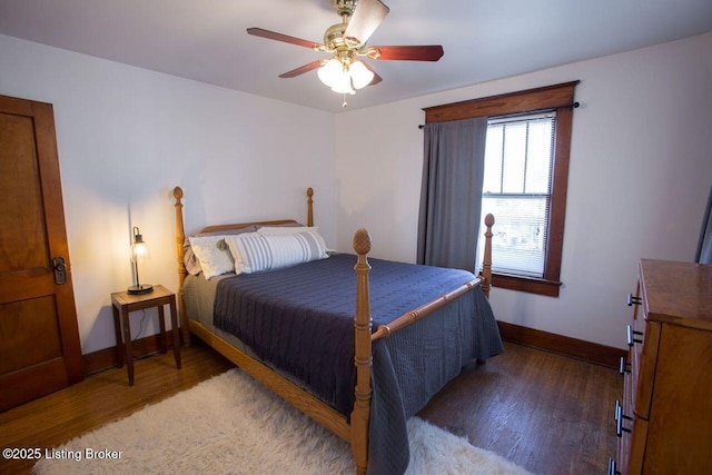 bedroom featuring ceiling fan, baseboards, and wood finished floors