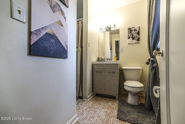 full bath with tile patterned floors, toilet, vanity, and baseboards