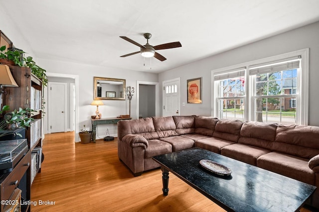 living area featuring light wood-style floors and a ceiling fan