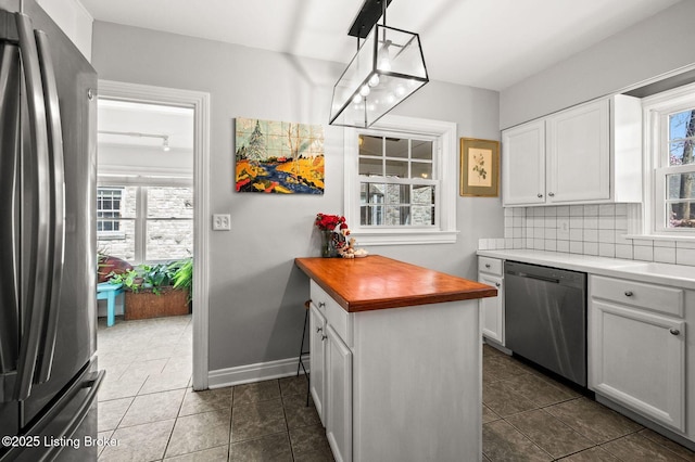 kitchen with white cabinets, plenty of natural light, tasteful backsplash, and appliances with stainless steel finishes