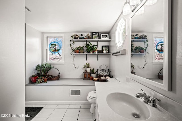 bathroom with vanity, toilet, baseboards, tile patterned floors, and visible vents