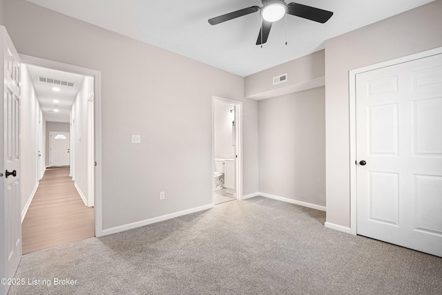 2064 Emmet Ave, Louisville, KY 40217 - unfurnished bedroom featuring ensuite bath, carpet, visible vents, and baseboards