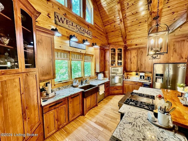 kitchen featuring wooden ceiling, a sink, brown cabinets, stainless steel appliances, and light stone counters