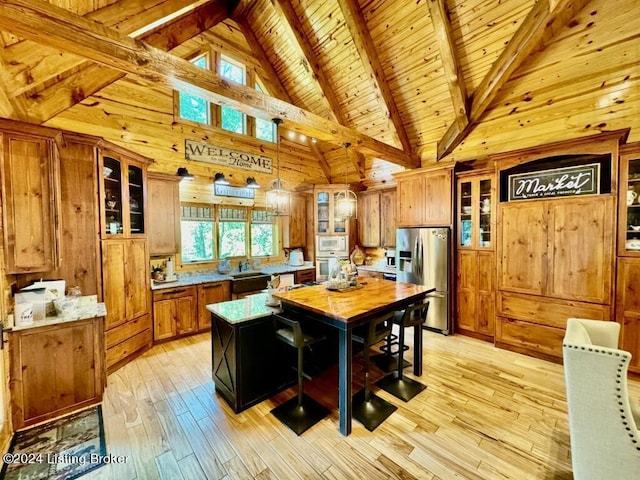 kitchen with brown cabinetry, appliances with stainless steel finishes, light wood-style floors, and wood ceiling
