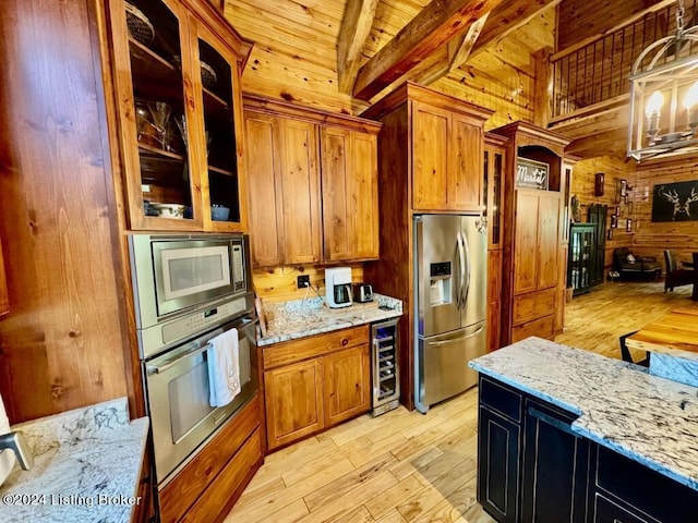 kitchen with wood ceiling, brown cabinets, light stone countertops, beverage cooler, and stainless steel appliances