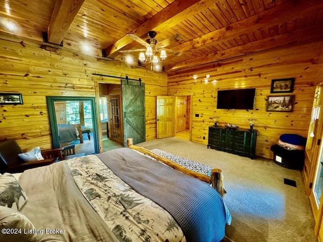 bedroom featuring wooden walls, beamed ceiling, a barn door, and wood ceiling