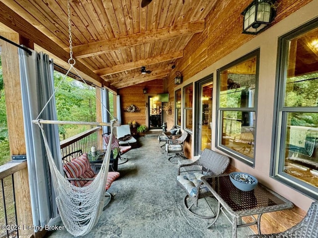 sunroom featuring beamed ceiling