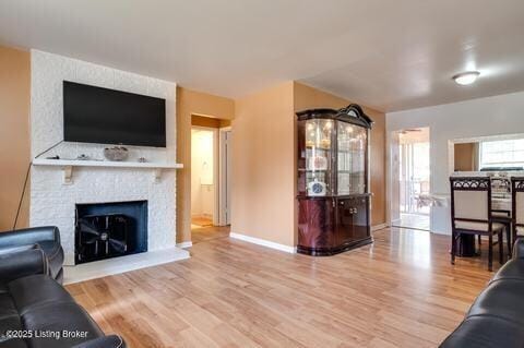 3307 Leith Ln Apt 3, Louisville, KY 40218 - living area featuring wood finished floors, baseboards, and a large fireplace
