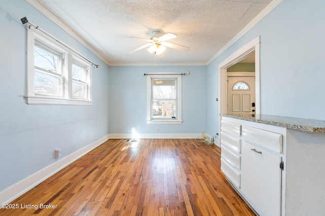 628 Harrison Ave, Louisville, KY 40217 - empty room featuring crown molding, hardwood / wood-style flooring, a textured ceiling, baseboards, and ceiling fan
