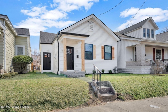 view of front of house with a front yard and roof with shingles