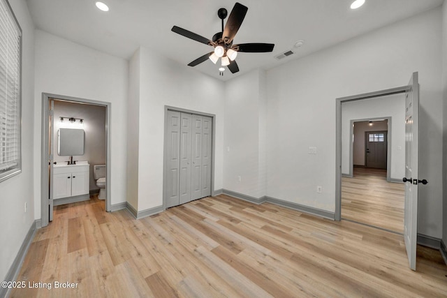 unfurnished bedroom featuring light wood-style flooring, ensuite bathroom, baseboards, visible vents, and recessed lighting