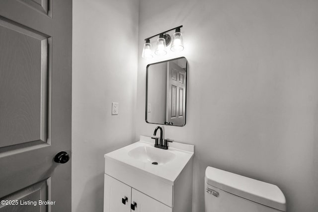 bathroom with toilet and vanity