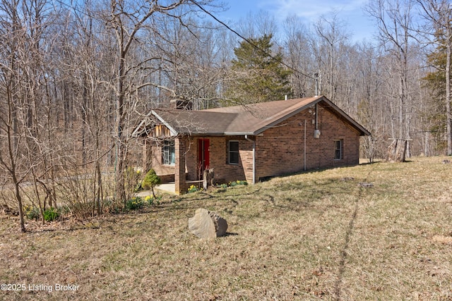 1147 Poplar Grove Rd, Buffalo, KY 42716 - view of front of house featuring a front yard, brick siding, a chimney, and a shingled roof