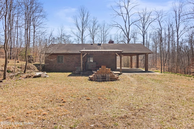 1147 Poplar Grove Rd, Buffalo, KY 42716 - back of property featuring a yard, brick siding, a chimney, and a patio