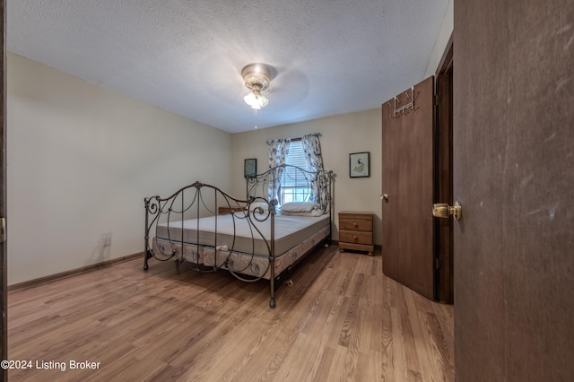110 Nathan Rd, Falls Of Rough, KY 40119 - bedroom with light wood finished floors, baseboards, and a textured ceiling