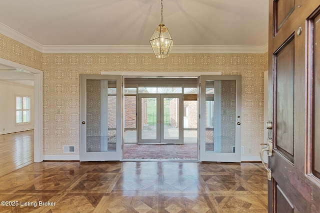 foyer with crown molding, wallpapered walls, french doors, baseboards, and visible vents