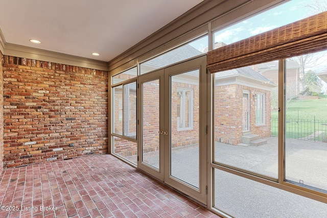 unfurnished sunroom featuring brick wall, french doors, brick floor, and recessed lighting