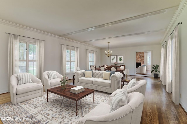 living room with baseboards, crown molding, hardwood / wood-style flooring, and an inviting chandelier