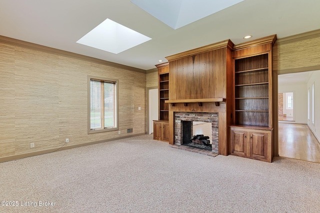 unfurnished living room with a fireplace, a wealth of natural light, a skylight, and recessed lighting
