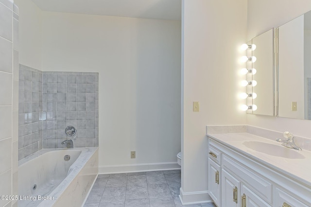 full bathroom featuring toilet, vanity, a garden tub, and baseboards