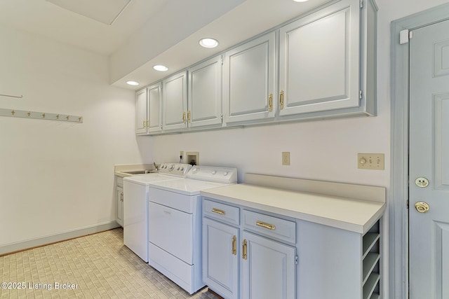 laundry area with a sink, baseboards, recessed lighting, separate washer and dryer, and cabinet space
