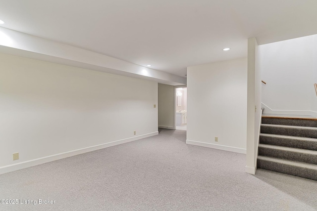 finished below grade area with carpet floors, baseboards, recessed lighting, and stairs