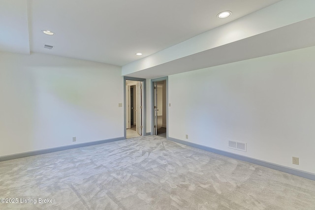 empty room featuring recessed lighting, visible vents, and light carpet
