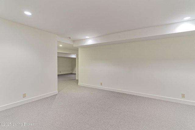 spare room with light carpet, baseboards, and recessed lighting
