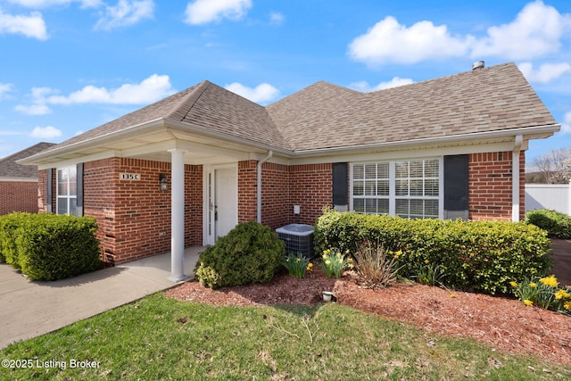 135C Michelle Dr, Shepherdsville, KY 40165 - view of front of home with brick siding, cooling unit, and roof with shingles