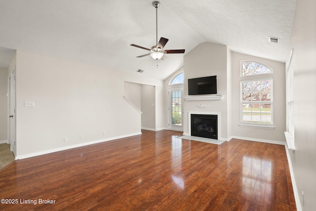135C Michelle Dr, Shepherdsville, KY 40165 - unfurnished living room with a healthy amount of sunlight, a fireplace with flush hearth, a ceiling fan, and wood finished floors