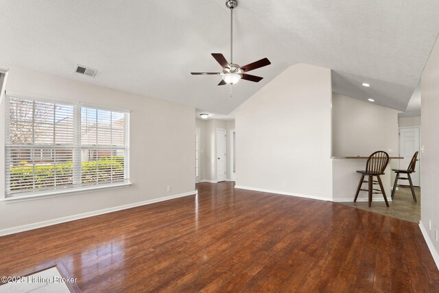 135C Michelle Dr, Shepherdsville, KY 40165 - unfurnished living room featuring a ceiling fan, visible vents, vaulted ceiling, wood finished floors, and baseboards