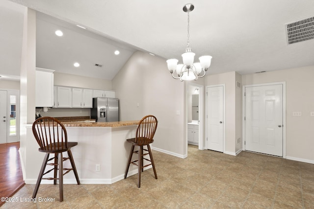 135C Michelle Dr, Shepherdsville, KY 40165 - kitchen featuring white cabinetry, a kitchen breakfast bar, a chandelier, and stainless steel fridge with ice dispenser