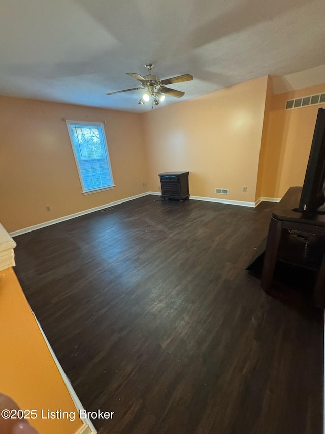 3324 Rainview Cir, Louisville, KY 40220 - living room featuring visible vents, baseboards, a ceiling fan, dark wood-style floors, and a wood stove