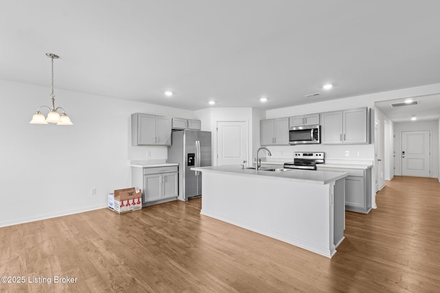 243 Zelcova Dr, Eminence, KY 40019 - kitchen with light wood-style flooring, gray cabinets, appliances with stainless steel finishes, a sink, and light countertops