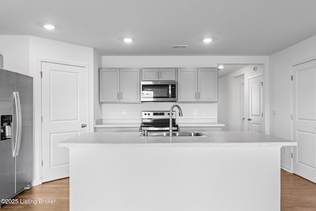 243 Zelcova Dr, Eminence, KY 40019 - kitchen featuring visible vents, a sink, appliances with stainless steel finishes, wood finished floors, and gray cabinets
